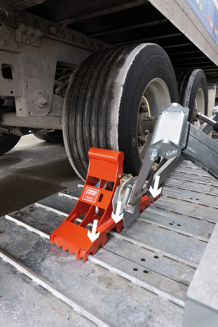 POWERCHOCK AUTO in use, securing a parked trailer's wheel
